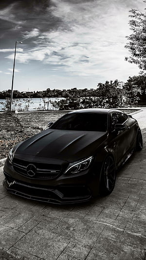 Matte Black Mercedes-AMG C63 Coupe Parked on Lakeside Pavement HD phone wallpaper
