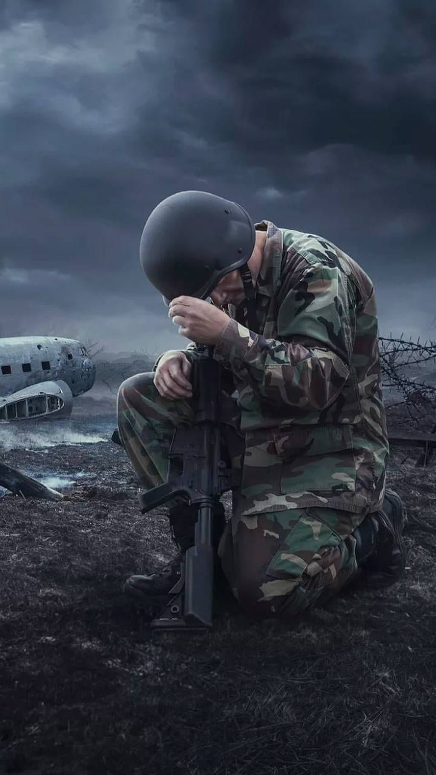Grieving Soldier Kneeling on a Dark Battlefield with Crashed Aircraft HD phone wallpaper