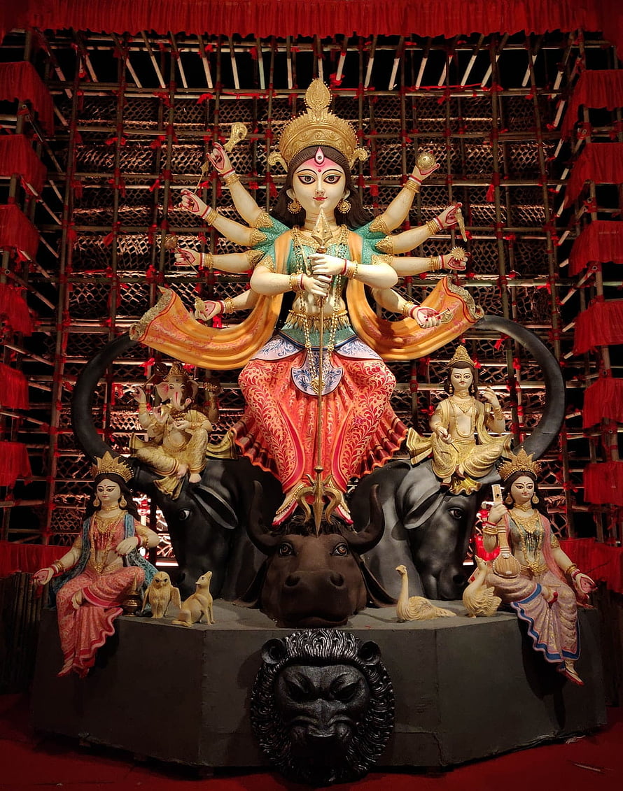 Durga Puja Idol of Goddess Durga Slaying Mahishasura with Multiple Arms and Divine Weapons HD phone wallpaper