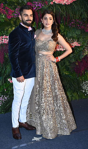 Virat Kohli and Anushka Sharma in Formal Attire at a Floral Event HD phone wallpaper