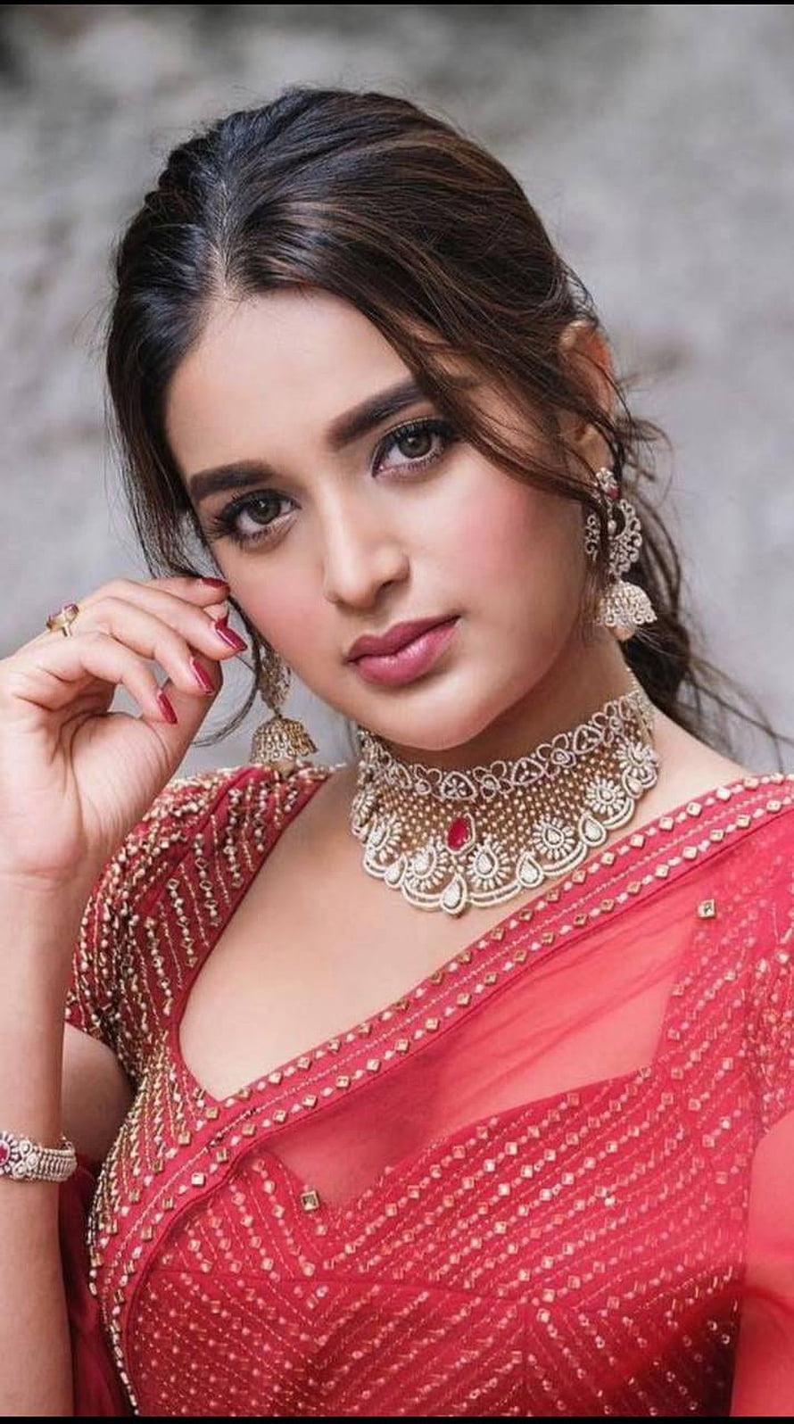 Nidhi Agarwal in a red embroidered lehenga with gold jewelry and traditional makeup HD phone wallpaper