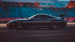 Black Toyota Supra JDM Widebody on a Race Track at Dusk HD wallpaper