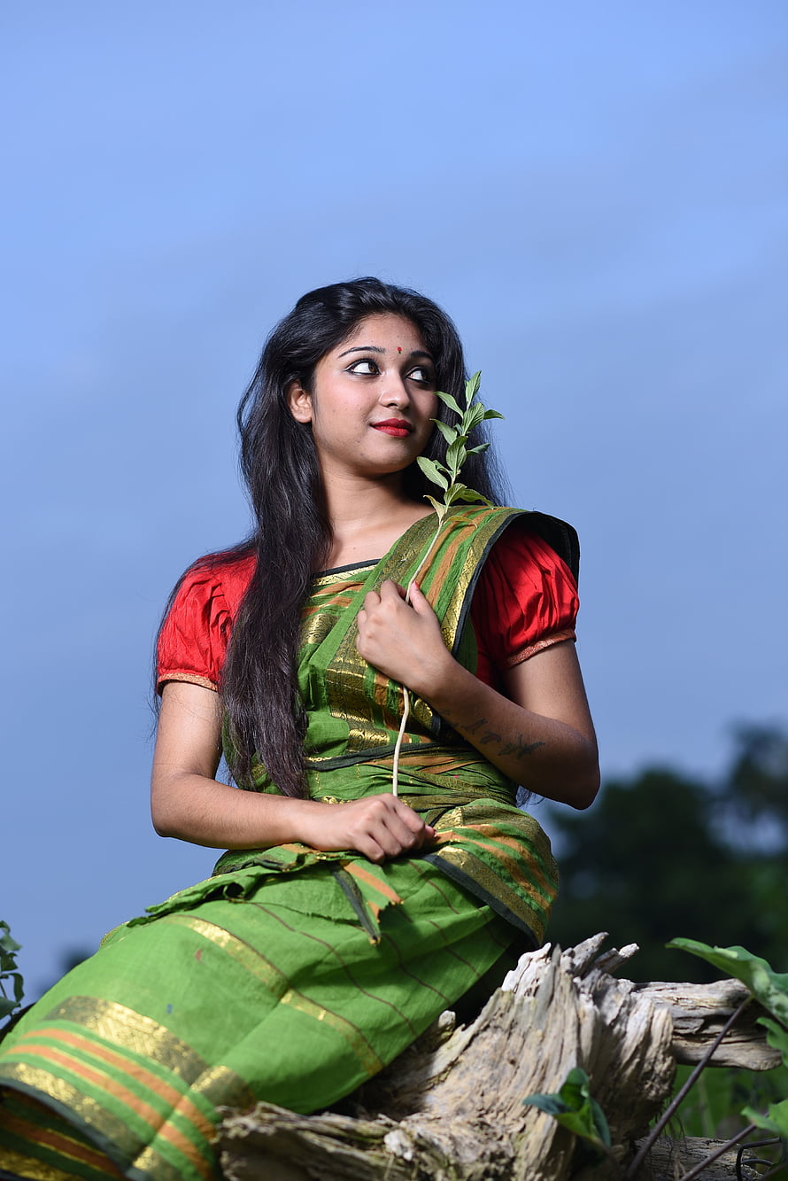 Bengali woman in green silk saree holding a leafy branch against a clear blue sky, stock of beautiful eyes, bengali, Bengali Girl, village beautiful girl HD phone wallpaper