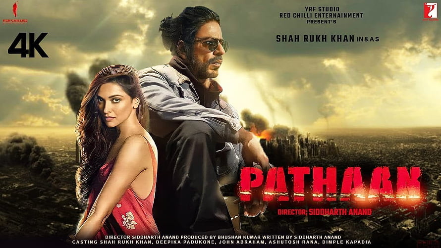 Pathaan Movie Poster Featuring Shah Rukh Khan and Deepika Padukone in Dramatic Action Scene HD wallpaper