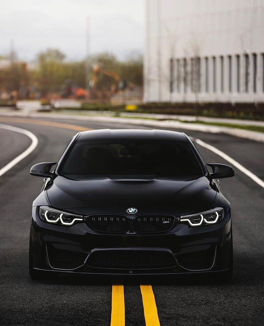 Matte Black BMW M4 Competition on a Curved Road with Yellow Lines HD phone wallpaper