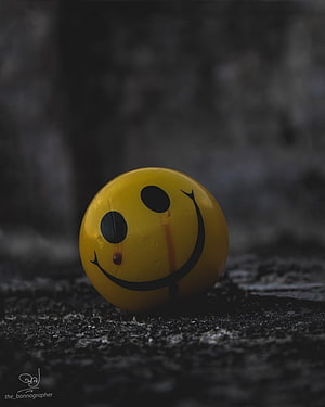 Crying Yellow Smile Ball on Dark Textured Surface HD phone wallpaper