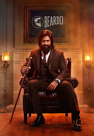 Yash in vintage three-piece suit with beard and cane seated in leather armchair HD phone wallpaper