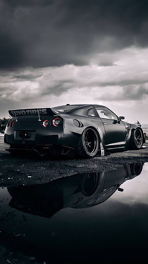 Matte Black Nissan GT-R R35 with Widebody Kit and Reflection in Rain HD phone wallpaper