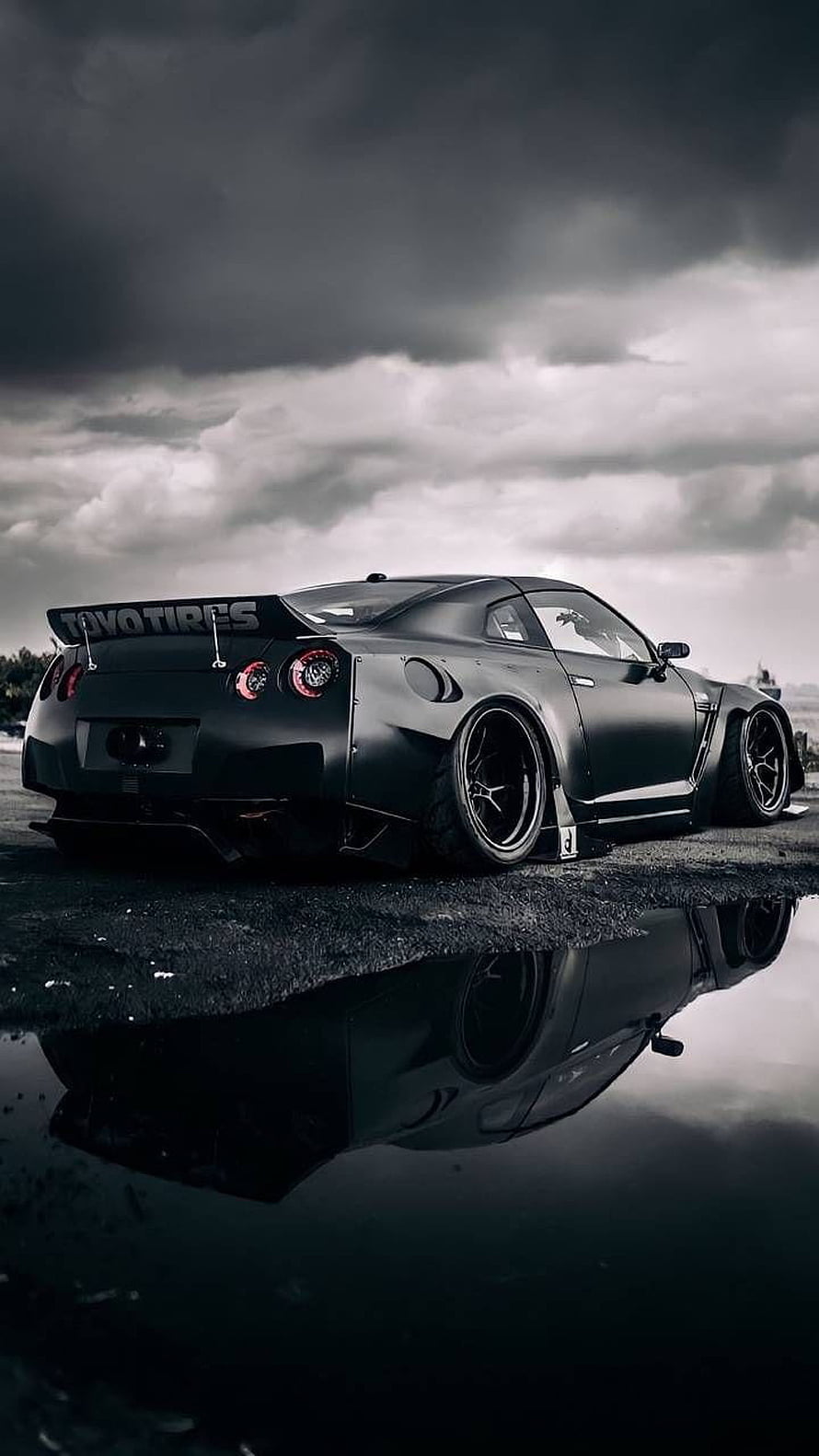 Matte Black Nissan GT-R R35 with Widebody Kit and Reflection in Rain HD phone wallpaper