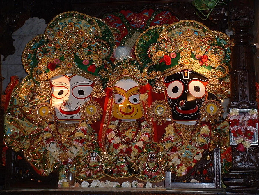 Traditional Jagannath Temple Deities with Ornate Crowns and Floral Offerings HD wallpaper