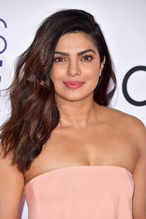 Priyanka Chopra in a Soft Pink Strapless Gown with Wavy Hair and Natural Makeup HD phone wallpaper