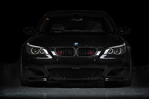 Black BMW E60 M5 Front View in Dark Studio Setting HD wallpaper
