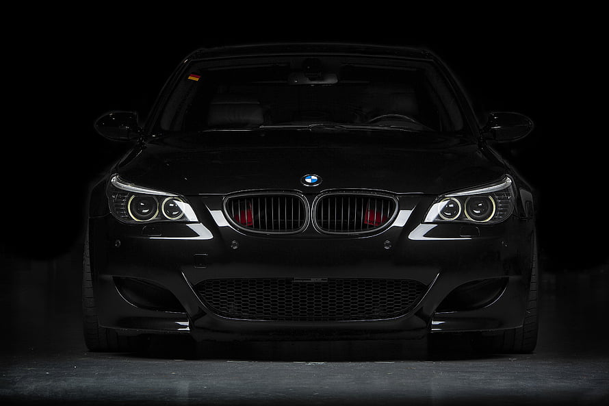 Black BMW E60 M5 Front View in Dark Studio Setting HD wallpaper