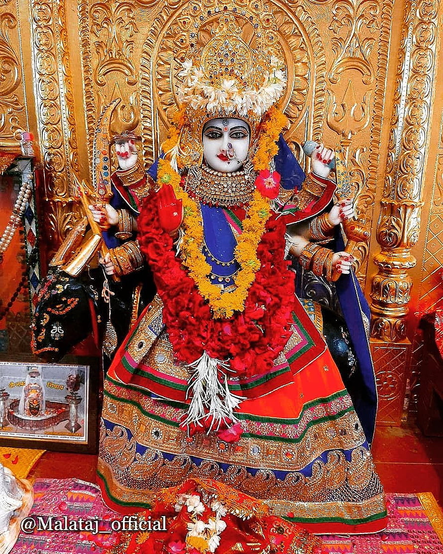 Ornate Malataj Maa Deity Idol Adorned With Red And Yellow Flower Garlands In Temple Setting HD phone wallpaper