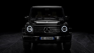 Black Mercedes-Benz G-Class Front View with LED Headlights in Dark Studio Setting HD wallpaper