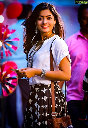 Sai Pallavi smiling portrait wearing white top and patterned skirt with earphones HD phone wallpaper