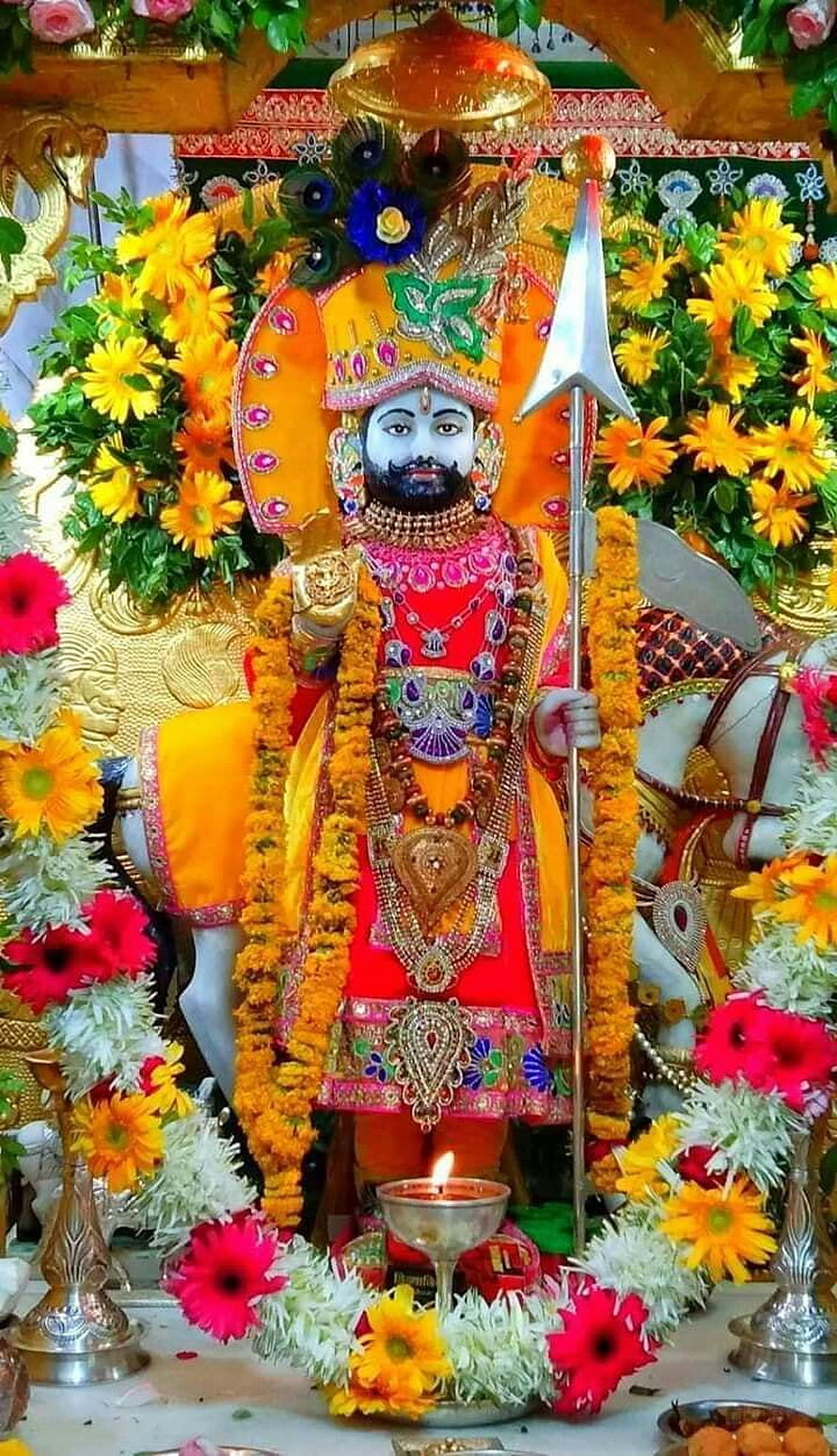 Vibrant Khatu Shyam Ji Temple Idol Surrounded by Marigold Garlands and Flowers HD phone wallpaper