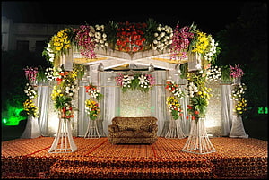 Elegant Indian Wedding Stage Decorated With Vibrant Floral Arrangements And Draped Fabric HD wallpaper