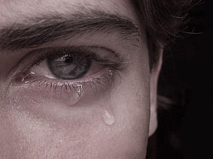Close-up portrait of a human eye with a single tear rolling down the cheek, capturing raw emotion and sadness in high detail, for Crying Boy The Eye of Love, sad eyes HD wallpaper