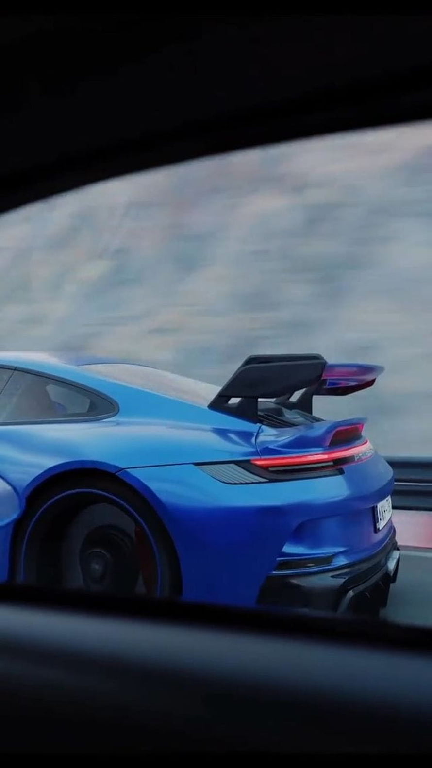 Rear Three-Quarter View of a Blue Porsche 992 GT3 with Prominent Rear Wing on a Track HD phone wallpaper