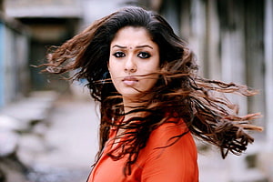 Sneha Portrait with Windblown Hair in Orange Top HD wallpaper