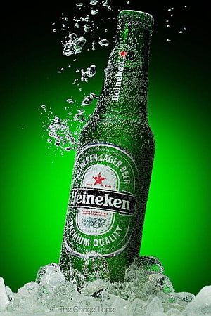 Chilled Heineken Lager Beer Bottle with Ice and Water Splash on Green Background HD phone wallpaper