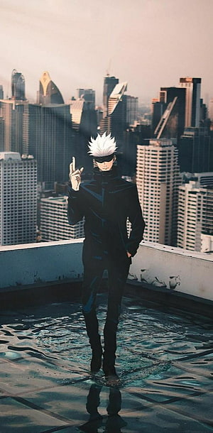 Gojo Satoru from Jujutsu Kaisen standing on a rooftop with city skyline background HD phone wallpaper