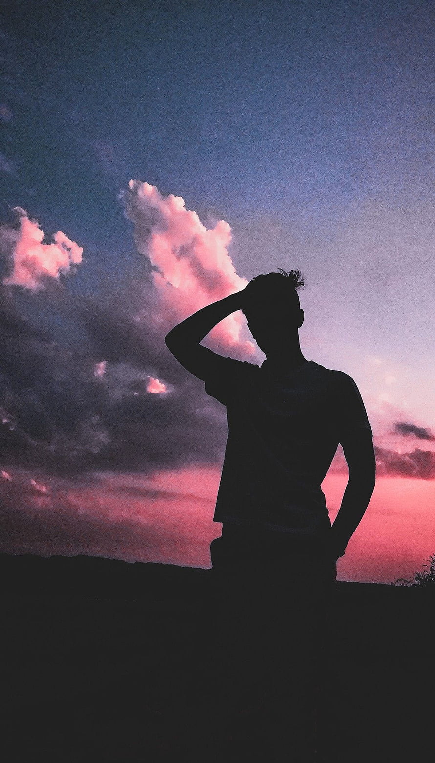 Silhouette of a man standing against a vibrant pink and purple sunset sky with dramatic clouds, Boy Shadow, sad pose boy HD phone wallpaper