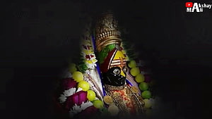 Tulja Bhavani Murti Adorned With Flowers And Gold Jewelry In Dark Temple Setting HD wallpaper
