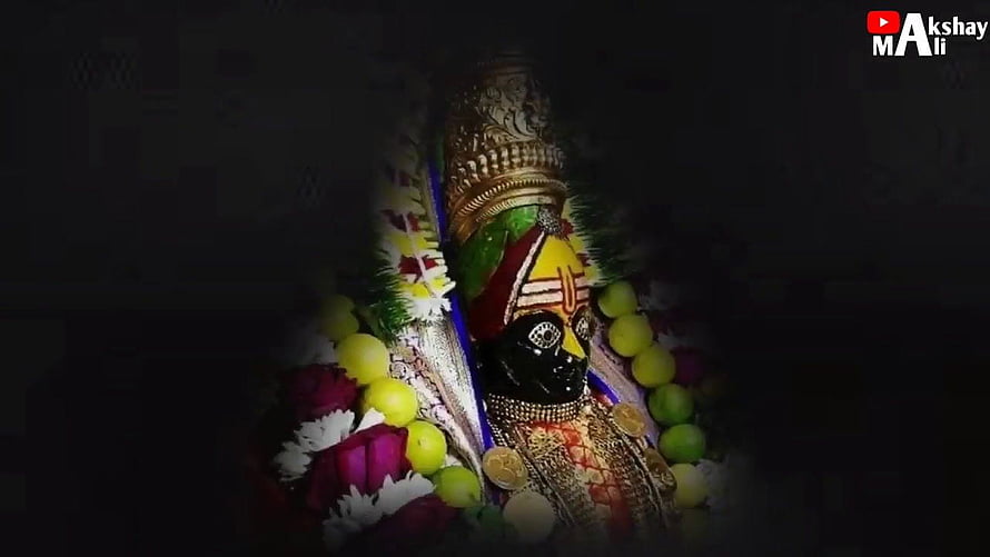 Tulja Bhavani Murti Adorned With Flowers And Gold Jewelry In Dark Temple Setting HD wallpaper