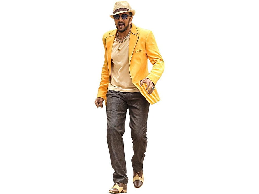 Kiccha Sudeep in a vibrant yellow blazer, fedora hat, and sunglasses against a white background HD wallpaper