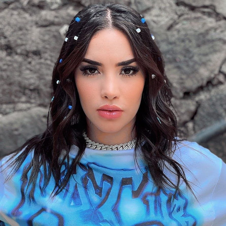 Kimberly Loaiza Portrait in Blue Patterned Top with Beaded Necklace and Hair Accessories HD phone wallpaper