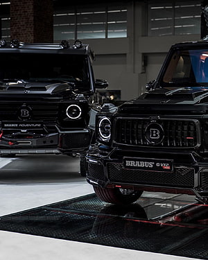 Black Brabus G V12 800 and Brabus Adventure G-Class SUVs in a Showroom HD phone wallpaper