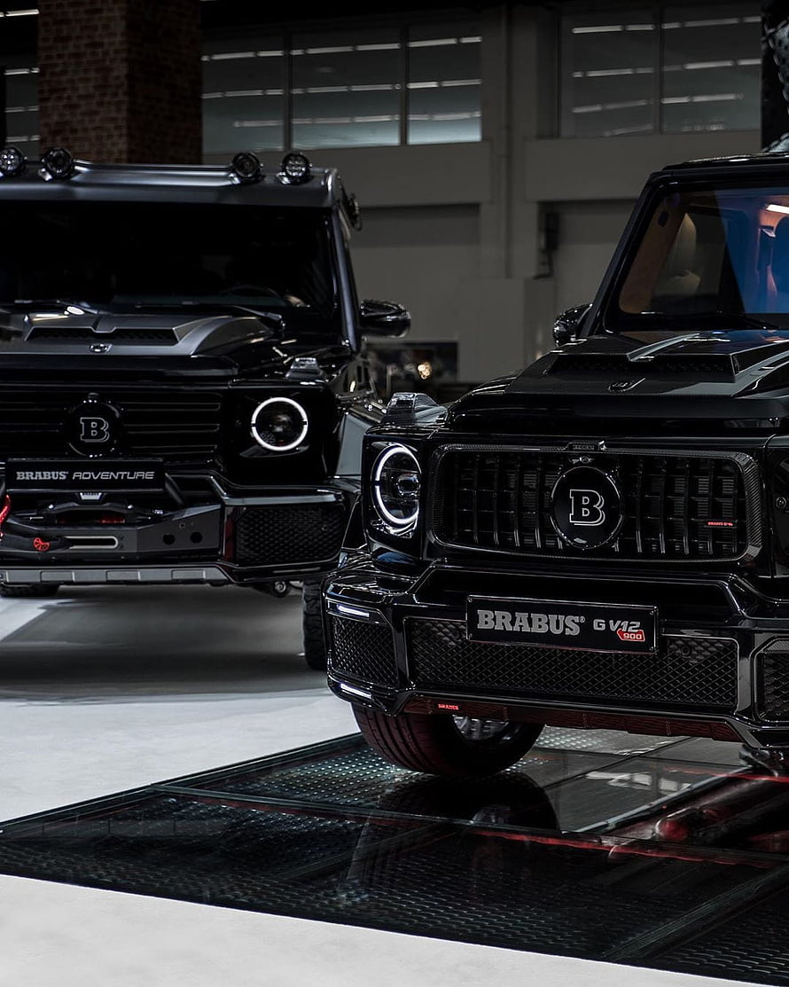 Black Brabus G V12 800 and Brabus Adventure G-Class SUVs in a Showroom HD phone wallpaper
