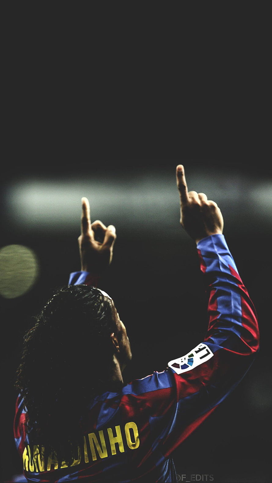 Ronaldinho in Barcelona Kit Pointing Upward in Dramatic Stadium Lighting HD phone wallpaper