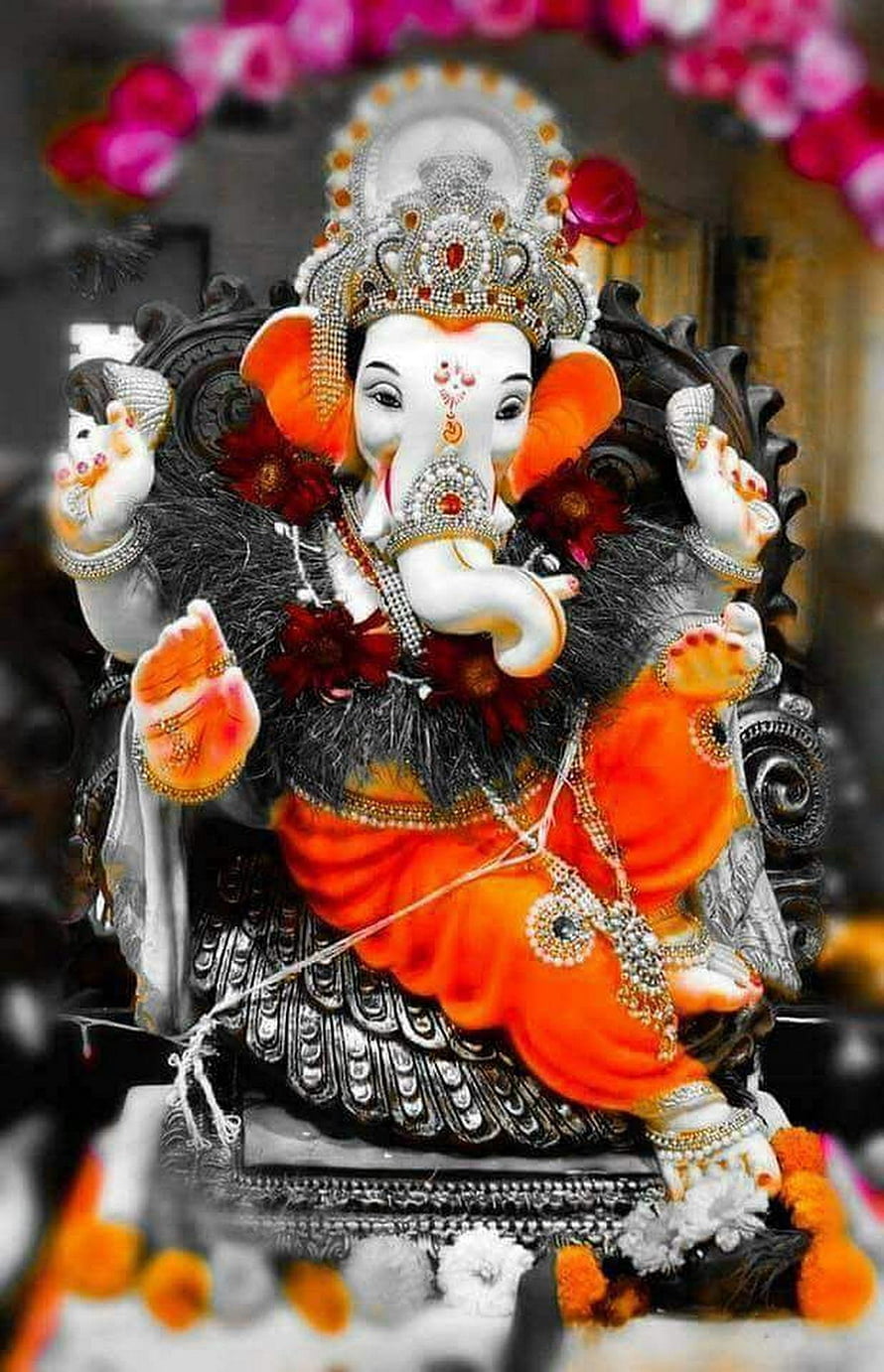 Ornate Ganesha Murti Adorned With Jewels, Marigold Garlands, and Floral Decorations HD phone wallpaper