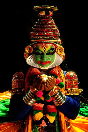 Portrait of Kathakali Dancer with Green Face Paint and Ornate Headdress HD phone wallpaper