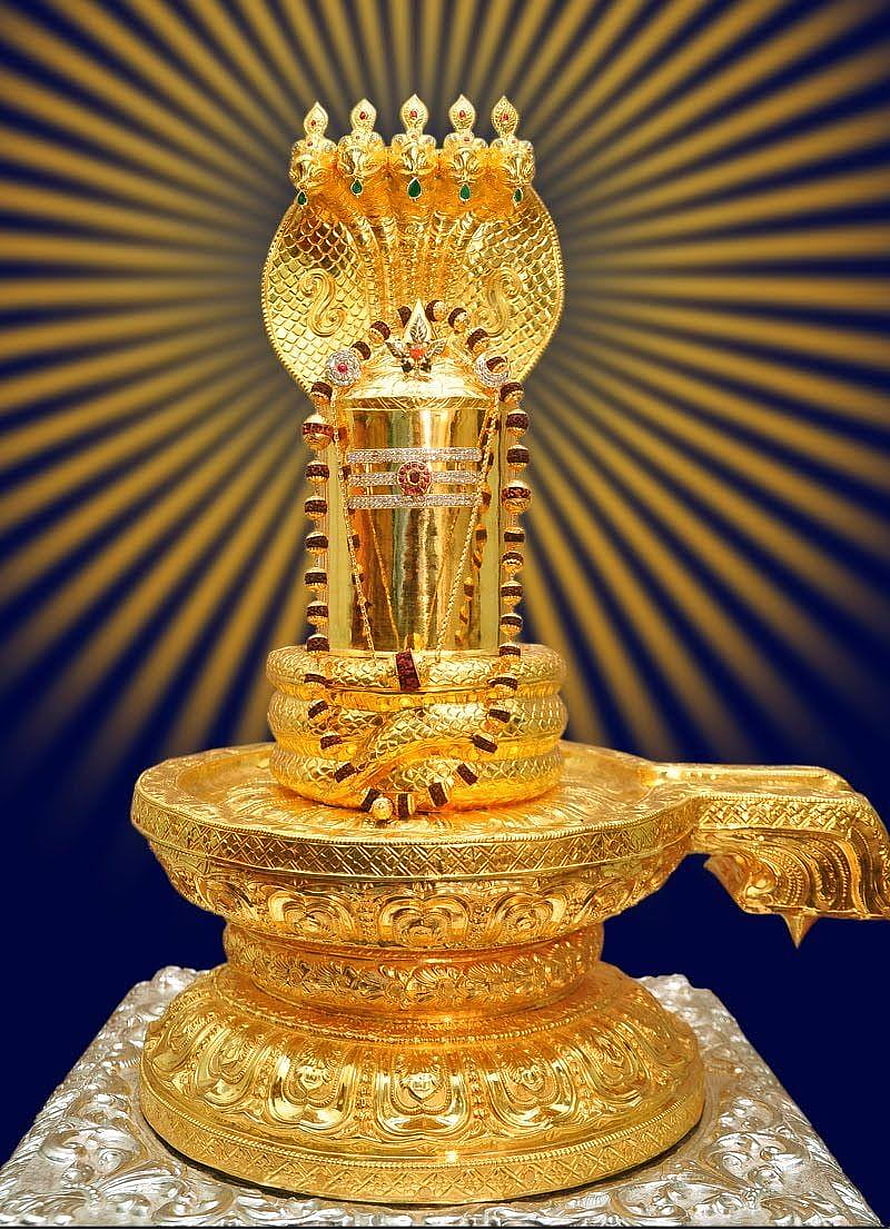 Ornate Golden Shiva Lingam with Multi-Headed Cobra Crown and Radiant Sunburst Background HD phone wallpaper
