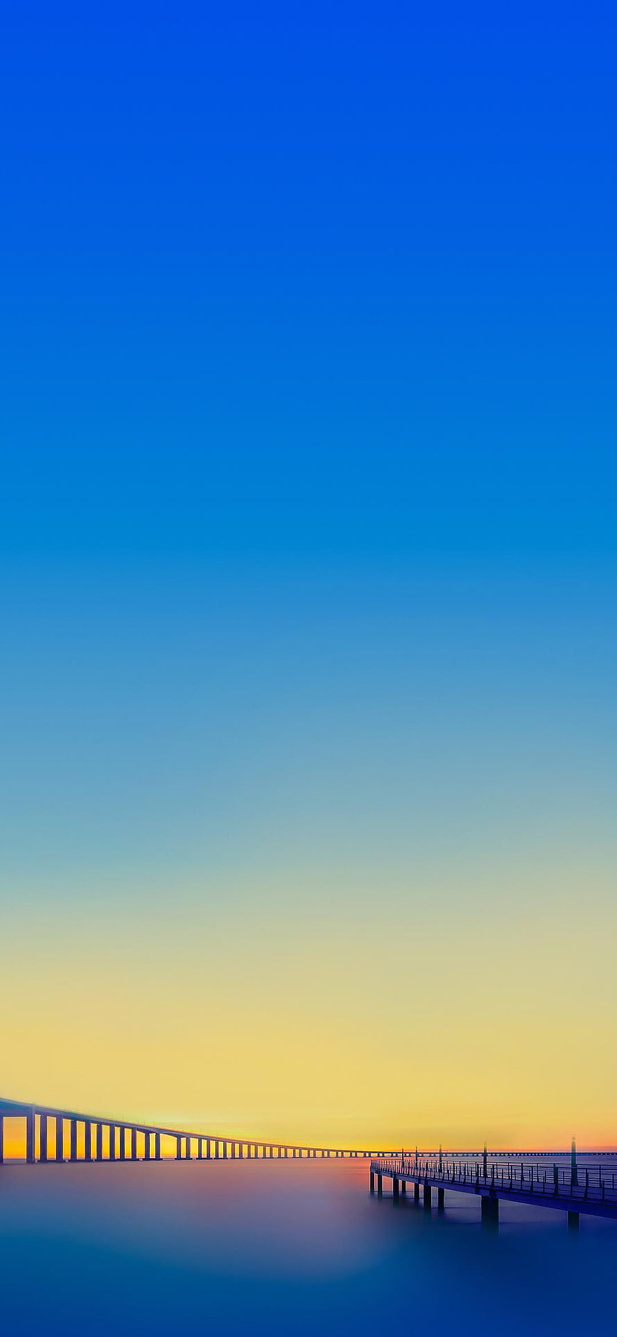 Serene Coastal Sunset with Long Bridge and Pier Silhouette Against Gradient Sky HD phone wallpaper