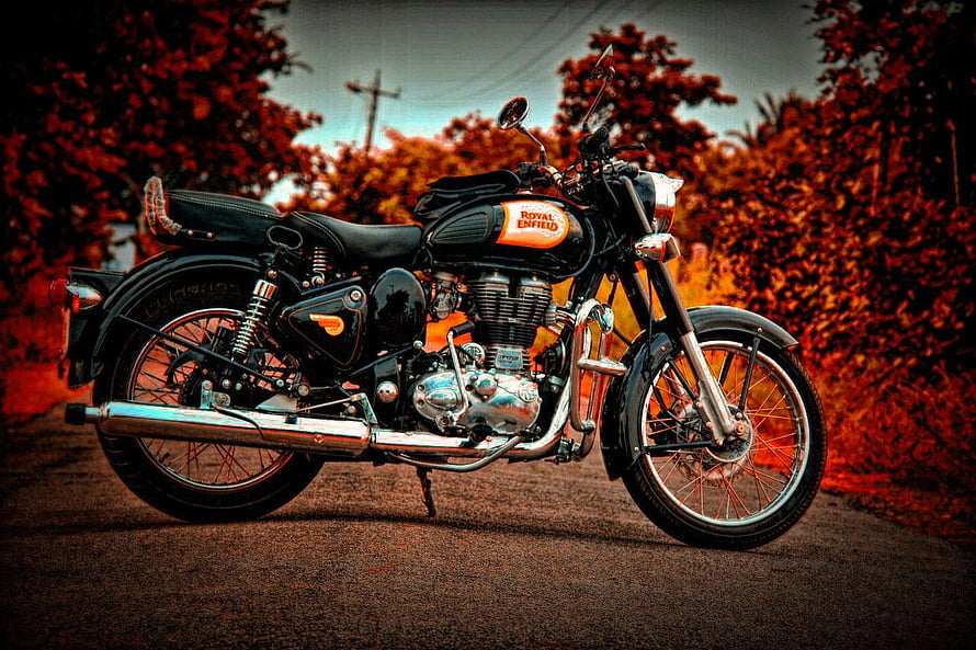 Classic Royal Enfield Bullet Motorcycle on a Road with Red Foliage HD wallpaper