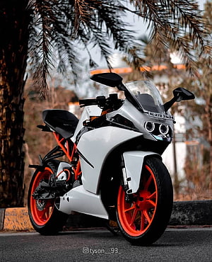 White KTM RC Sport Motorcycle with Orange Frame and Wheels Parked on Street HD phone wallpaper