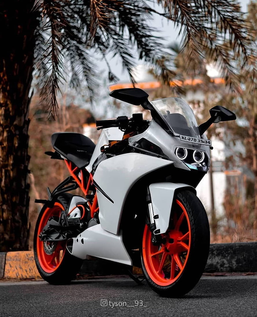 White KTM RC Sport Motorcycle with Orange Frame and Wheels Parked on Street HD phone wallpaper