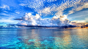 Stunning Ocean View With Dramatic Clouds And Turquoise Waters HD wallpaper