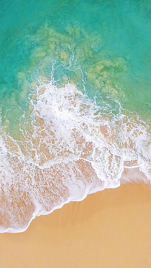 Aerial View of Turquoise Ocean Waves Crashing on Golden Sandy Beach HD phone wallpaper