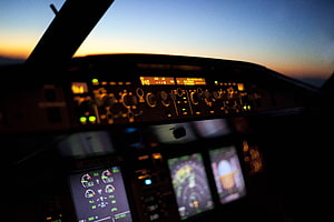Airplane Cockpit Dashboard at Sunset with Glowing Instrument Panels and Flight Controls HD wallpaper