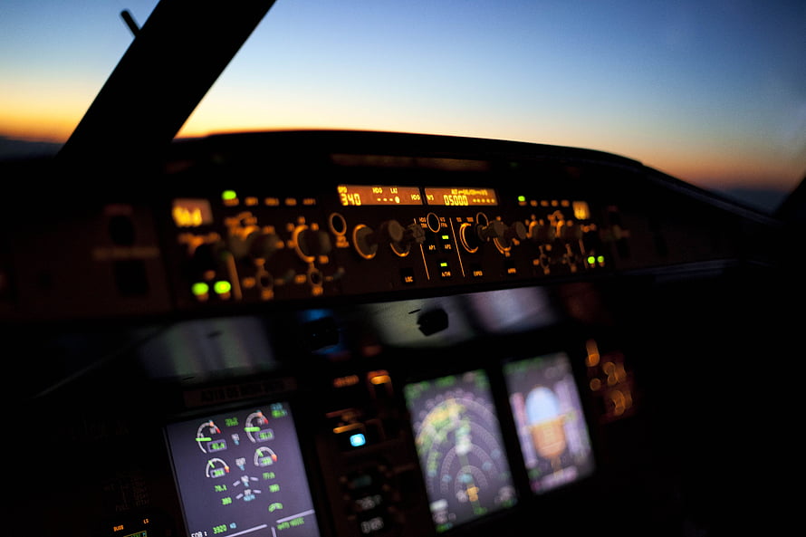 Airplane Cockpit Dashboard at Sunset with Glowing Instrument Panels and Flight Controls HD wallpaper