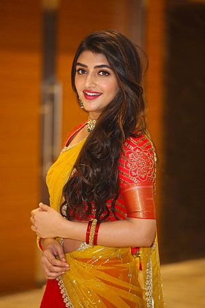 Pooja Hegde in a stunning yellow and red saree with traditional jewelry and elegant hairstyle HD phone wallpaper