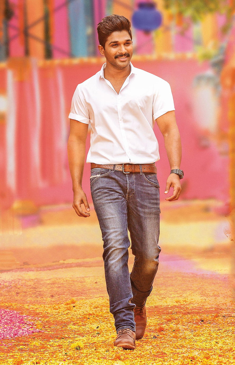 Allu Arjun Walking Through Colorful Holi Festival Scene in White Shirt and Jeans HD phone wallpaper