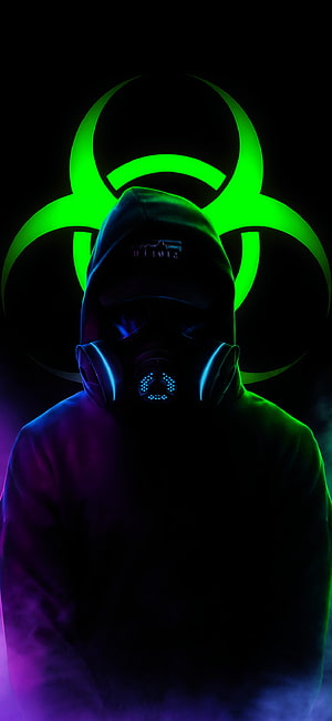 Hooded Figure in Gas Mask with Glowing Green Biohazard Symbol on Dark Background HD phone wallpaper