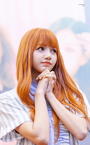 Lisa from BLACKPINK with vibrant orange hair and striped shirt in a soft portrait HD phone wallpaper